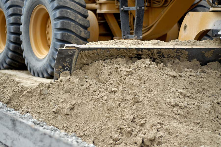 closeup of dirt being pushed by excavator waldport or