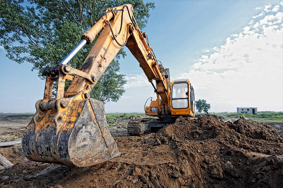 excavator moving dirt lakeside or